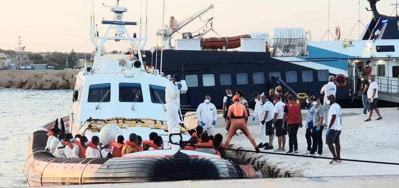 Migrants disembark from the the class 300 patrol boat of the Coast Guard which in Maltese SAR waters transhipped 49 migrants. 