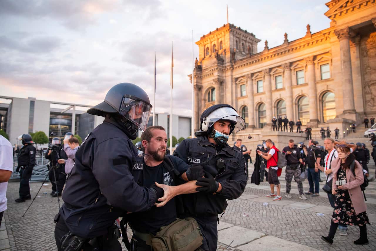 Police officers remove demonstrators from the square.