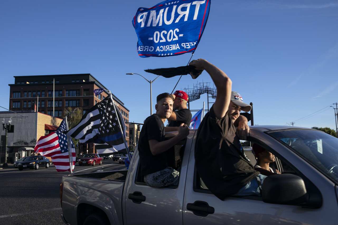 Supporters of President Donald Trump attend a rally and car parade in Clackamas, Oregon, on the way to Portland.