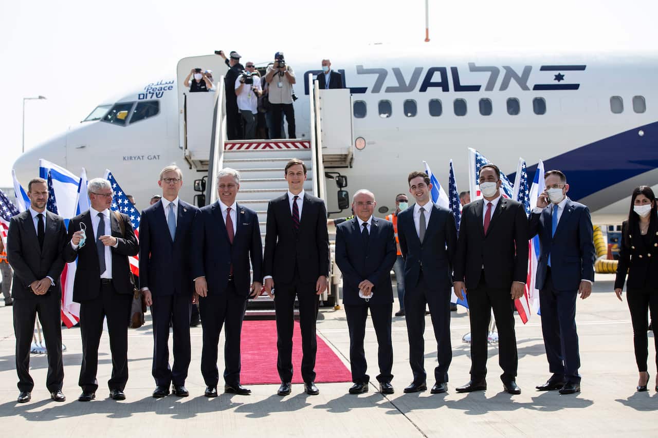 Israeli and American delegations pose for a photo before their departure to Abu Dhabi, at Ben-Gurion Airport, in Lod, near Tel Aviv, Israel.