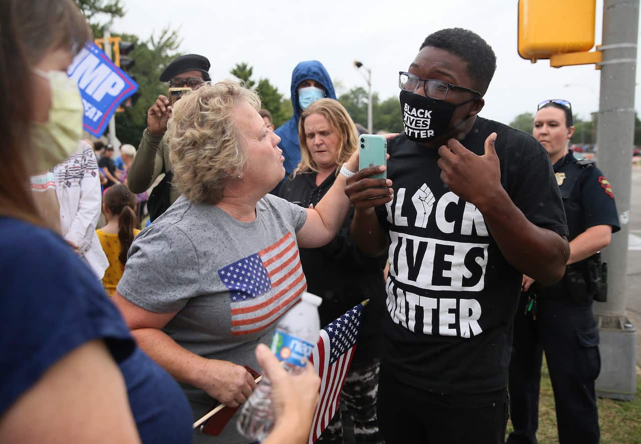 Supporters of President Donald Trump and a Black Lives Matter supporter face off in Kenosha, Wisconsin. 