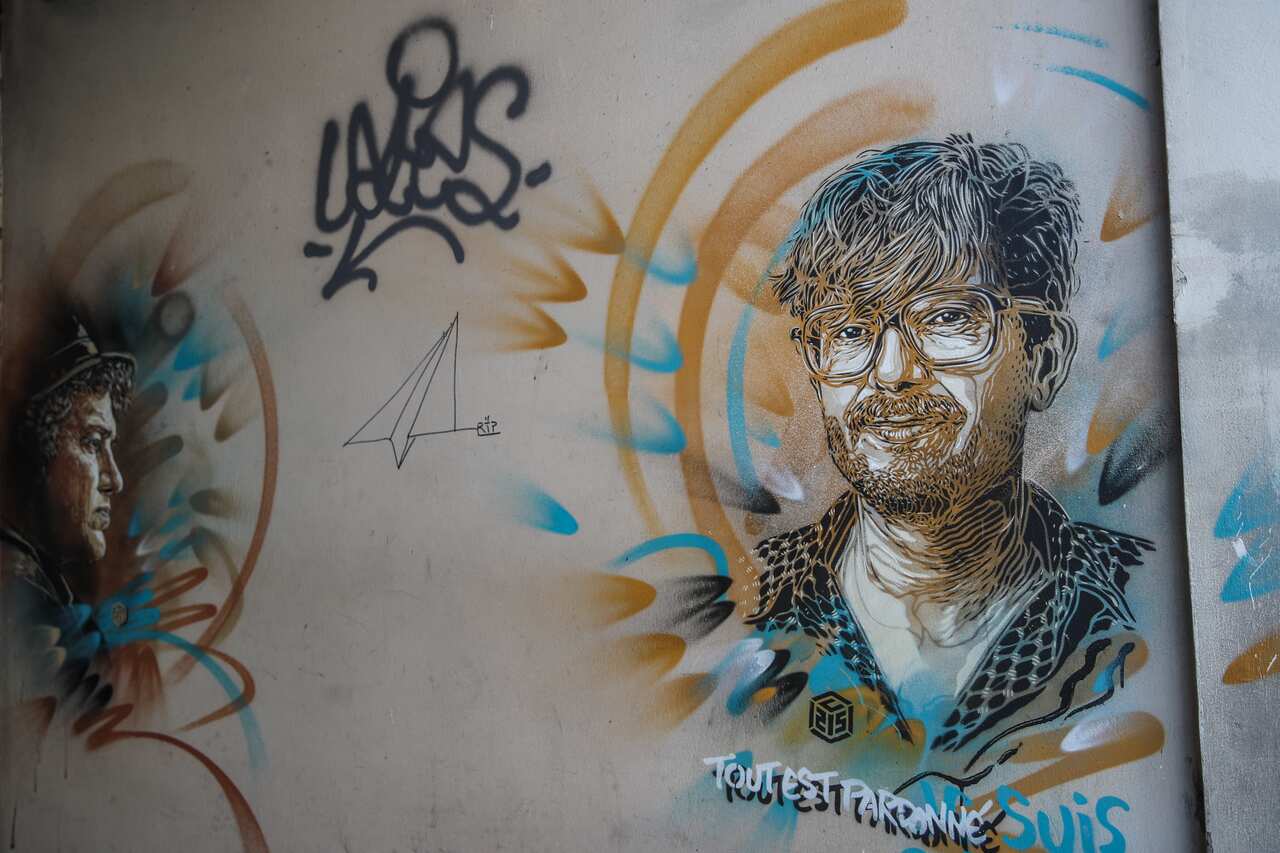 A painting depicting two of Charlie Hebdo's killed cartoonists outside the satirical newspaper's former office in Paris on 2 September.