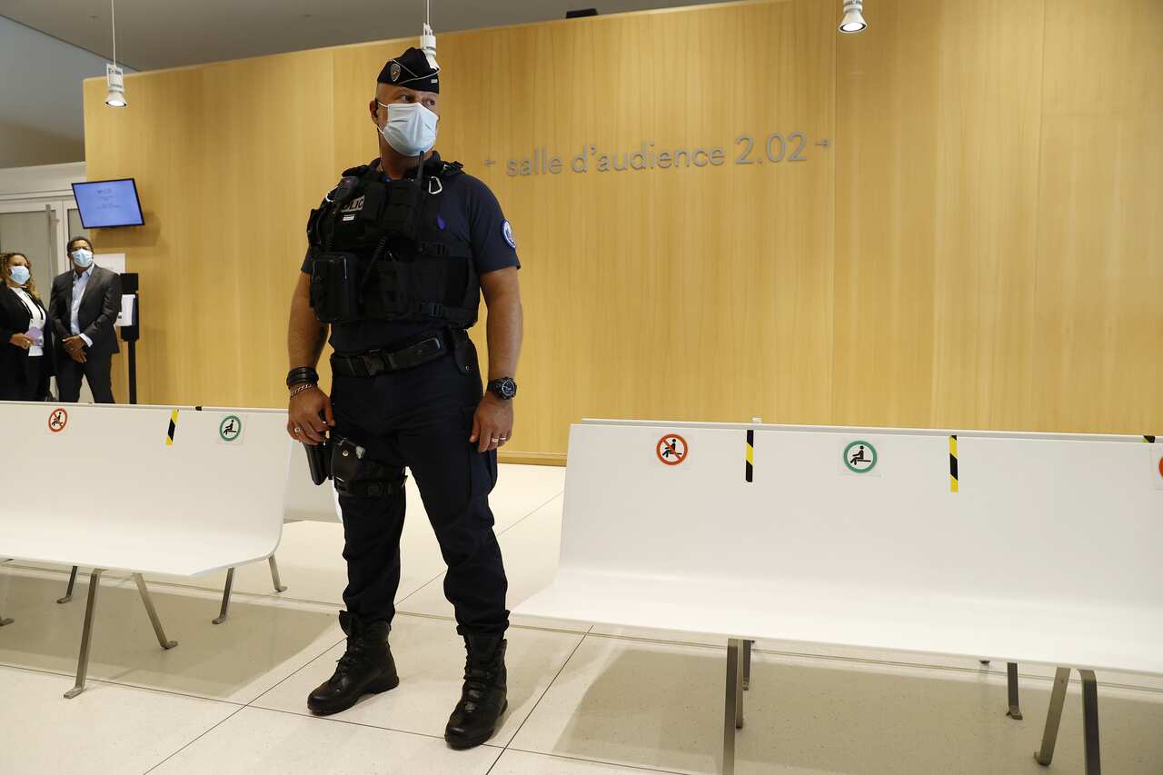 A French police officer stands guard outside the courtroom in which the Charlie Hebdo terror attack trial is being held.
