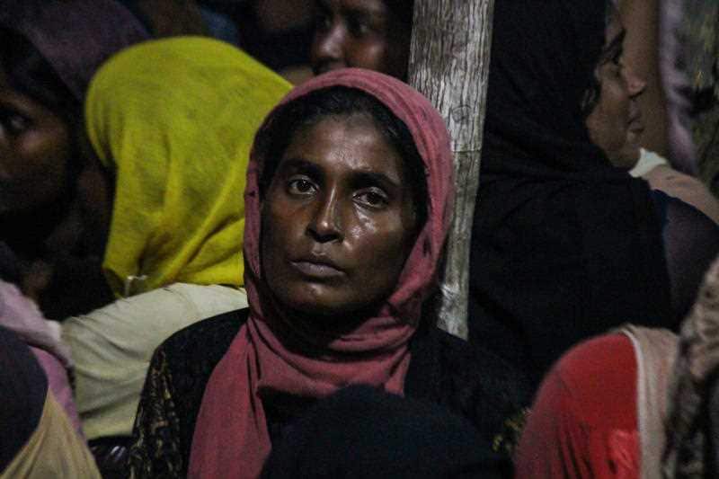 Rohingya residents gather in a hut after the ship they were travelling on was stranded on Ujong Blang beach.