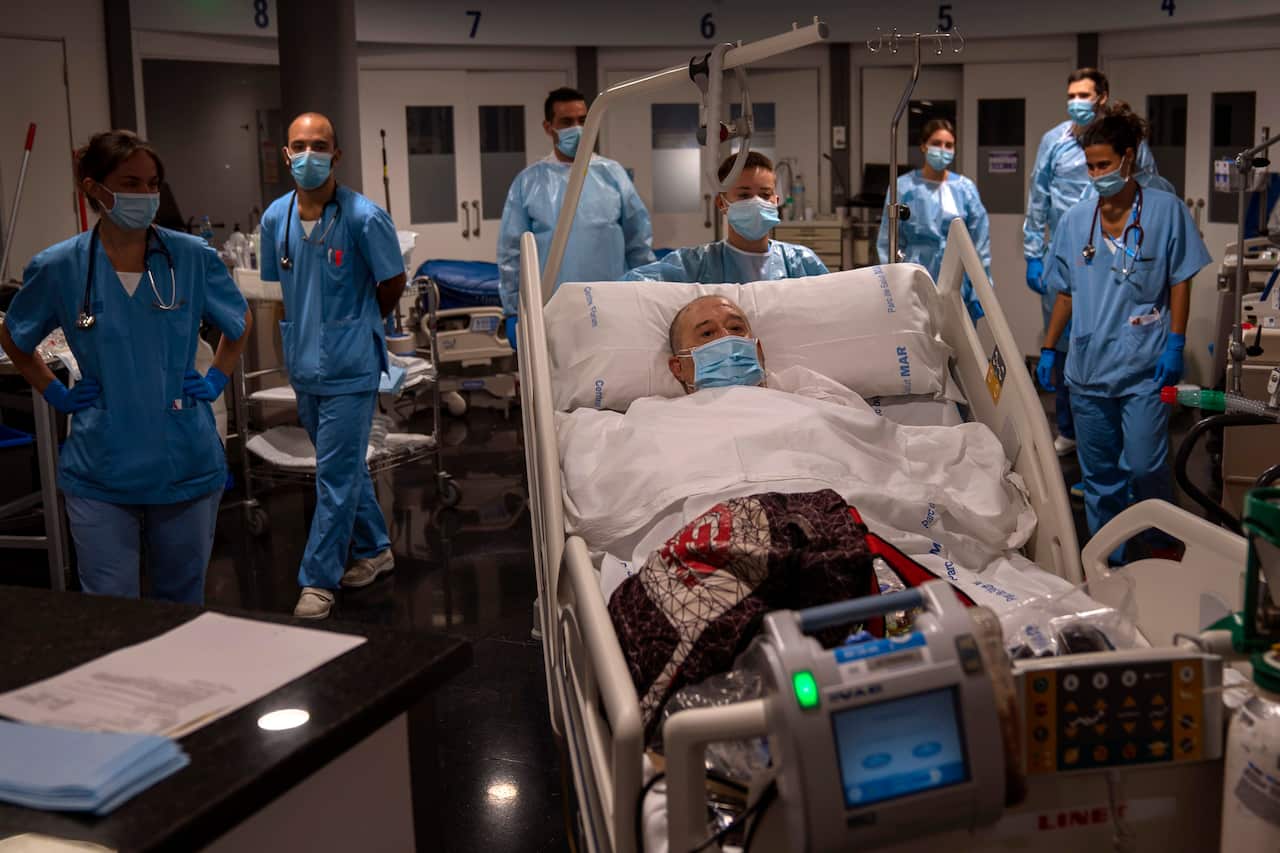 A coronavirus patient leaves the Intense Care Unit after 55 days in Barcelona, Spain.