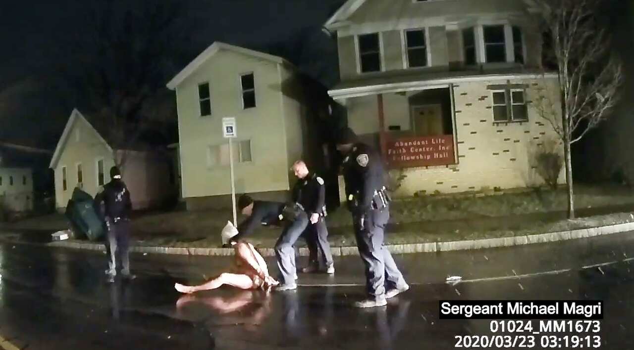 In this image taken from police body camera video a Rochester police officer puts a hood over the head of Daniel Prude, on 23 March, 2020, in Rochester, NY.