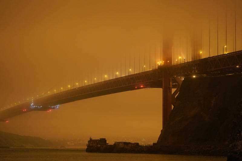 The Golden Gate Bridge in San Francisco is barely visible through smoke from wildfires Wednesday morning, Sept. 9, 2020