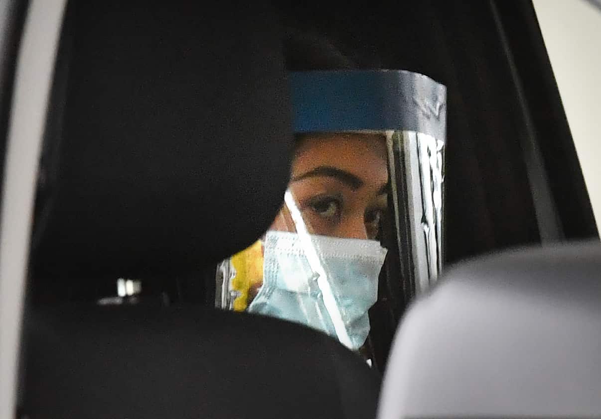 Sarah Caisip is seen wearing protective masks as she leaves the site of a funeral for her father Bernard Prendergast in Brisbane, Thursday, 10 September, 2020.