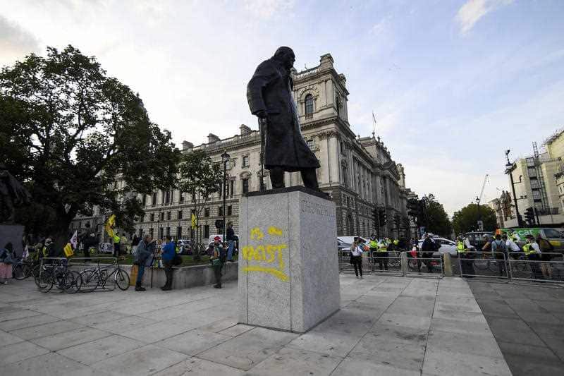 The statue of Winston Churchill in Parliament Square is seen with graffiti reading 'is a racist' on the plinth, in London, Thursday, Sept. 10, 2020
