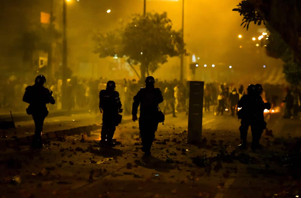 Riot police confront demonstrators during a protest in Bogota on 10 September.