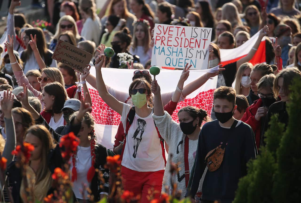 Protesters join a women's march in support of the opposition in central Minsk on 12 September.