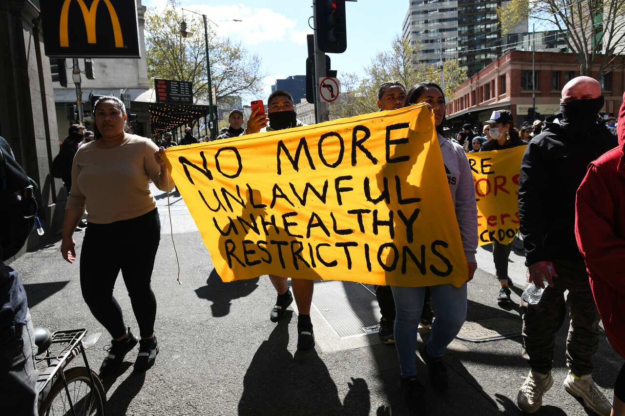 Protesters march through the CBD during an anti-lockdown protest in Melbourne, Sunday, September 13, 2020. 