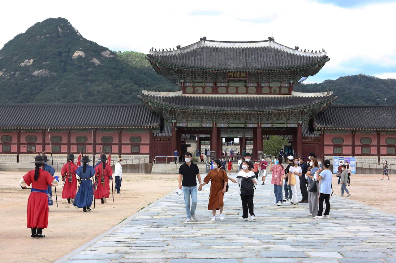 People wearing face masks to help protect against the spread of the coronavirus visit the Gyeongbok Palace in Seoul, South Korea, Sunday, Sept. 13, 2020. (AP Photo/Ahn Young-joon)