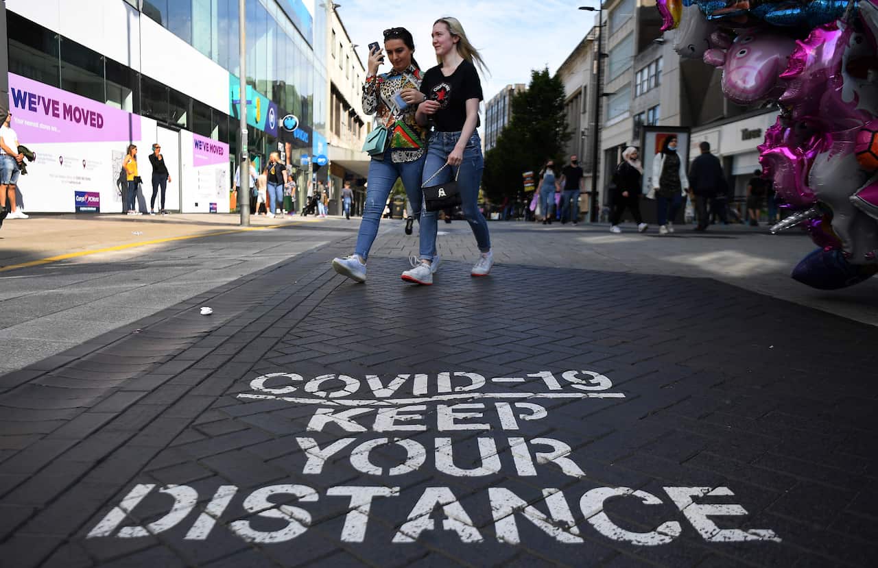 A Covid-19 social distancing public notice on a street in Birmingham, Britain.