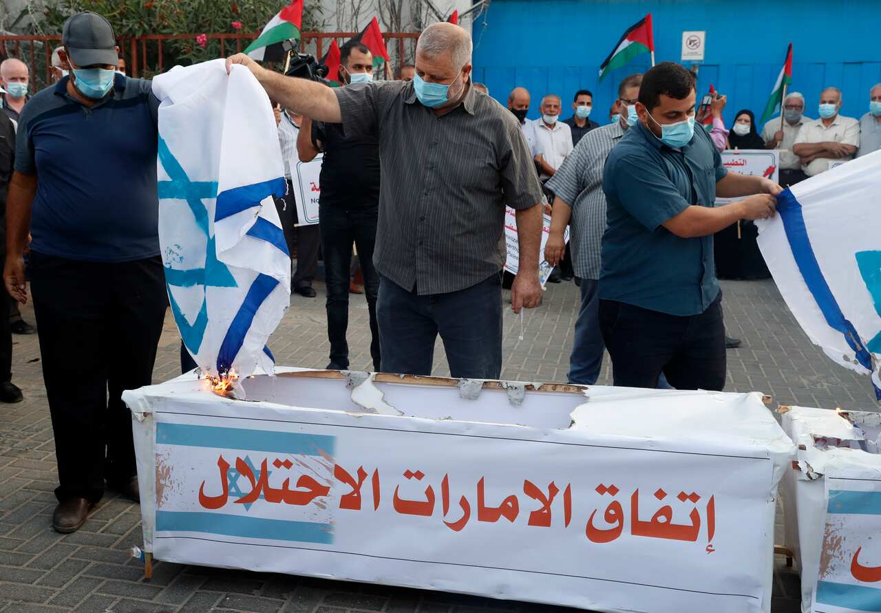 Palestinian protesters set fire to Israeli flags and mock coffins representing the Arab Emirates and Bahraini normalisation agreements with Israel.