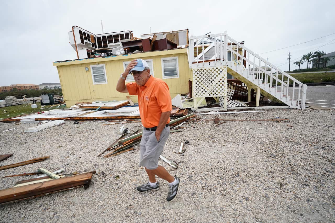 Joe Mirable surveys the damage to his business after Hurricane Sally.