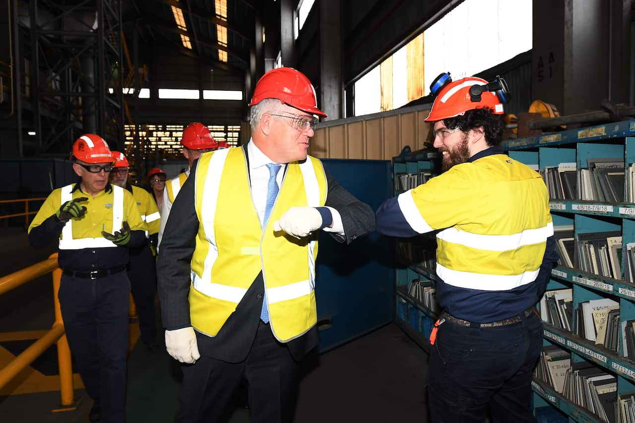 Prime Minister Scott Morrison (centre) meets steel workers during a visit to BlueScope Steel in Port Kembla, Wollongong, NSW.