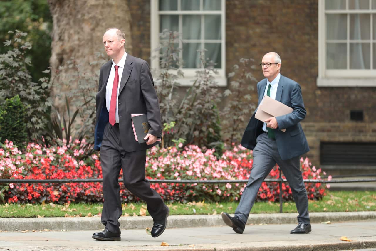 The government's chief medical officer Chris Whitty (left) and chief scientific adviser Patrick Vallance arrive at Downing Street ahead of the briefing.