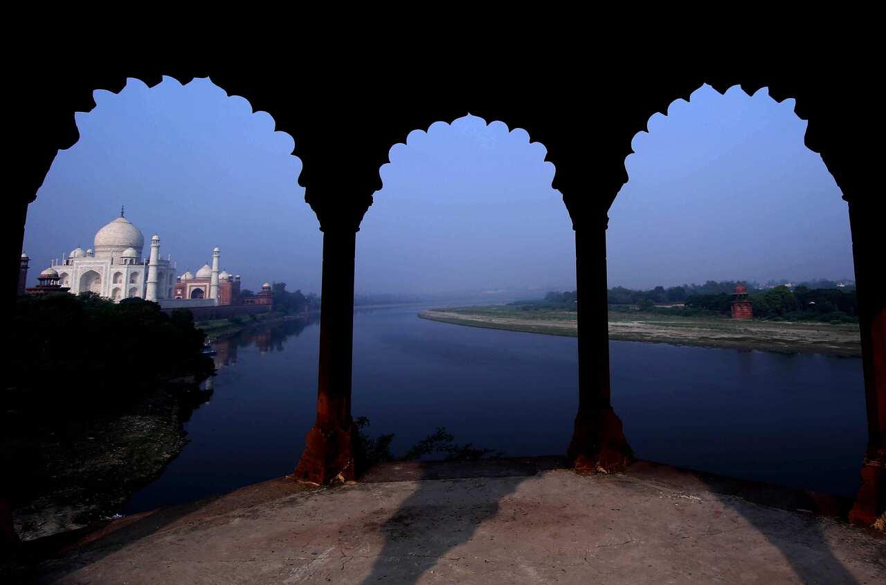 The Taj Mahal monument is seen on the banks of the river Yamuna early morning in Agra, India.