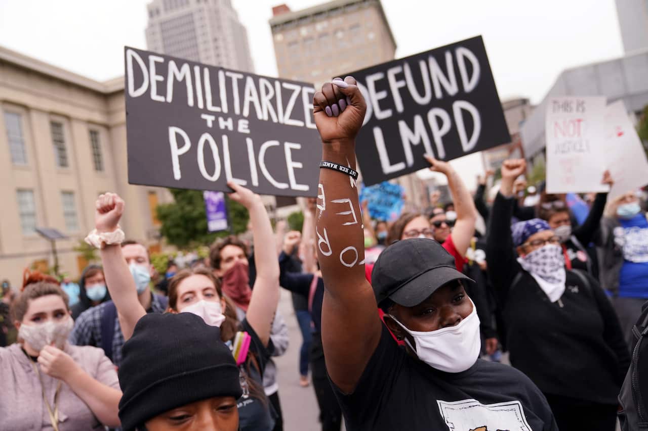 Protesters speak, Wednesday, Sept. 23, 2020, in Louisville, Ky. A grand jury has indicted one officer on criminal charges six months after Breonna Taylor was fatally shot by police in Kentucky. 