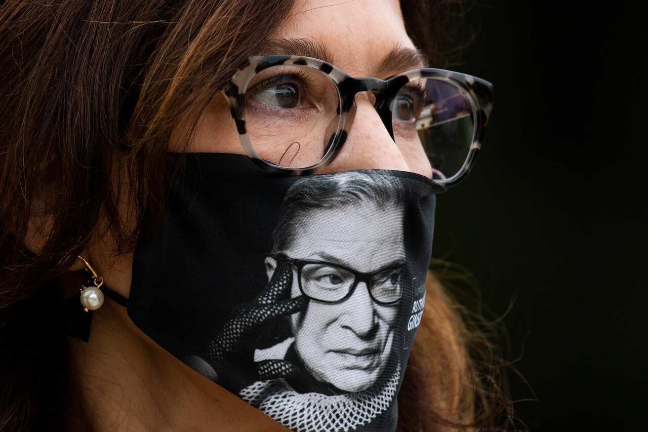 Attorney Lucinda Gardner of Washington, DC, wears a face mask depicting the image of late US Supreme Court Justice Ruth Bader Ginsburg.