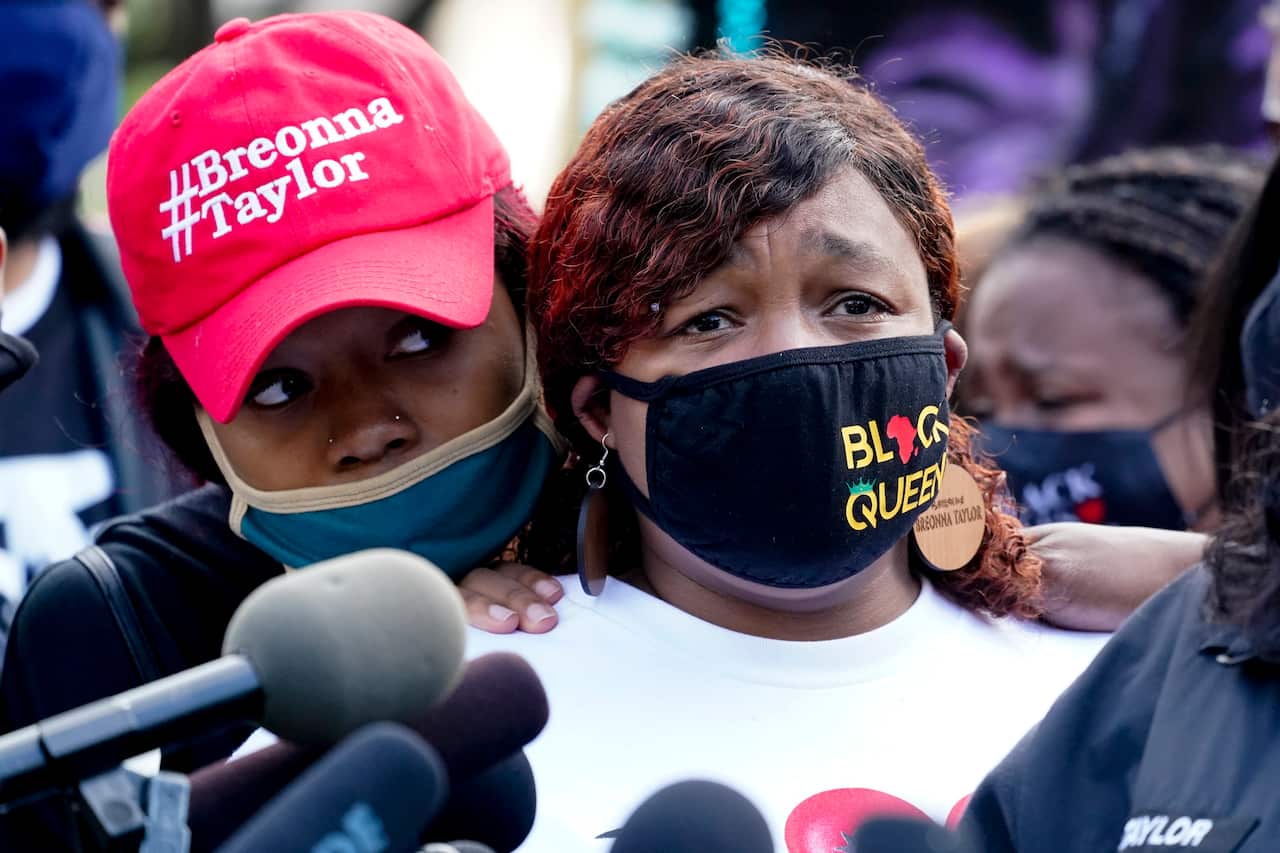 Breonna Taylor's mother Tamika Palmer, right, listens to a news conference on 25 September.