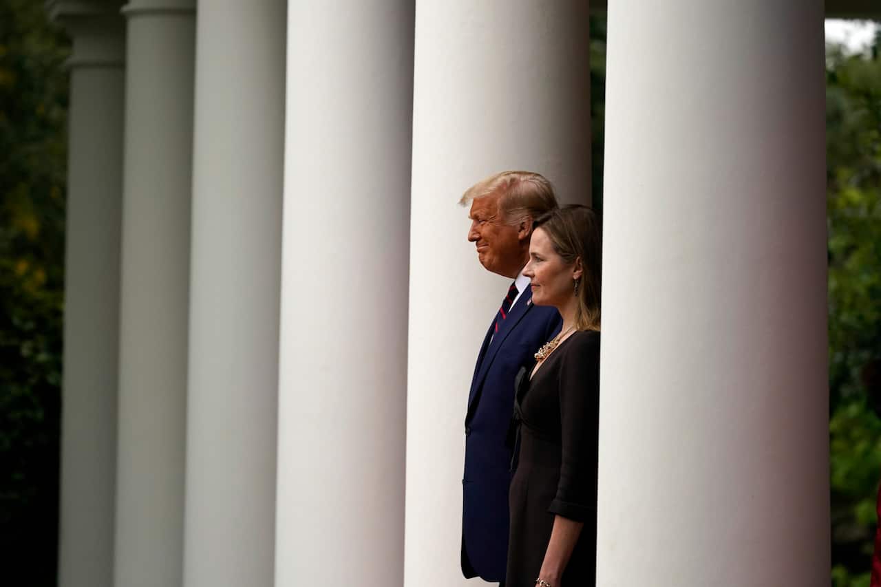 US President Donald Trump walks with Judge Amy Coney Barrett to announce her nomination for Supreme Court Justice. 
