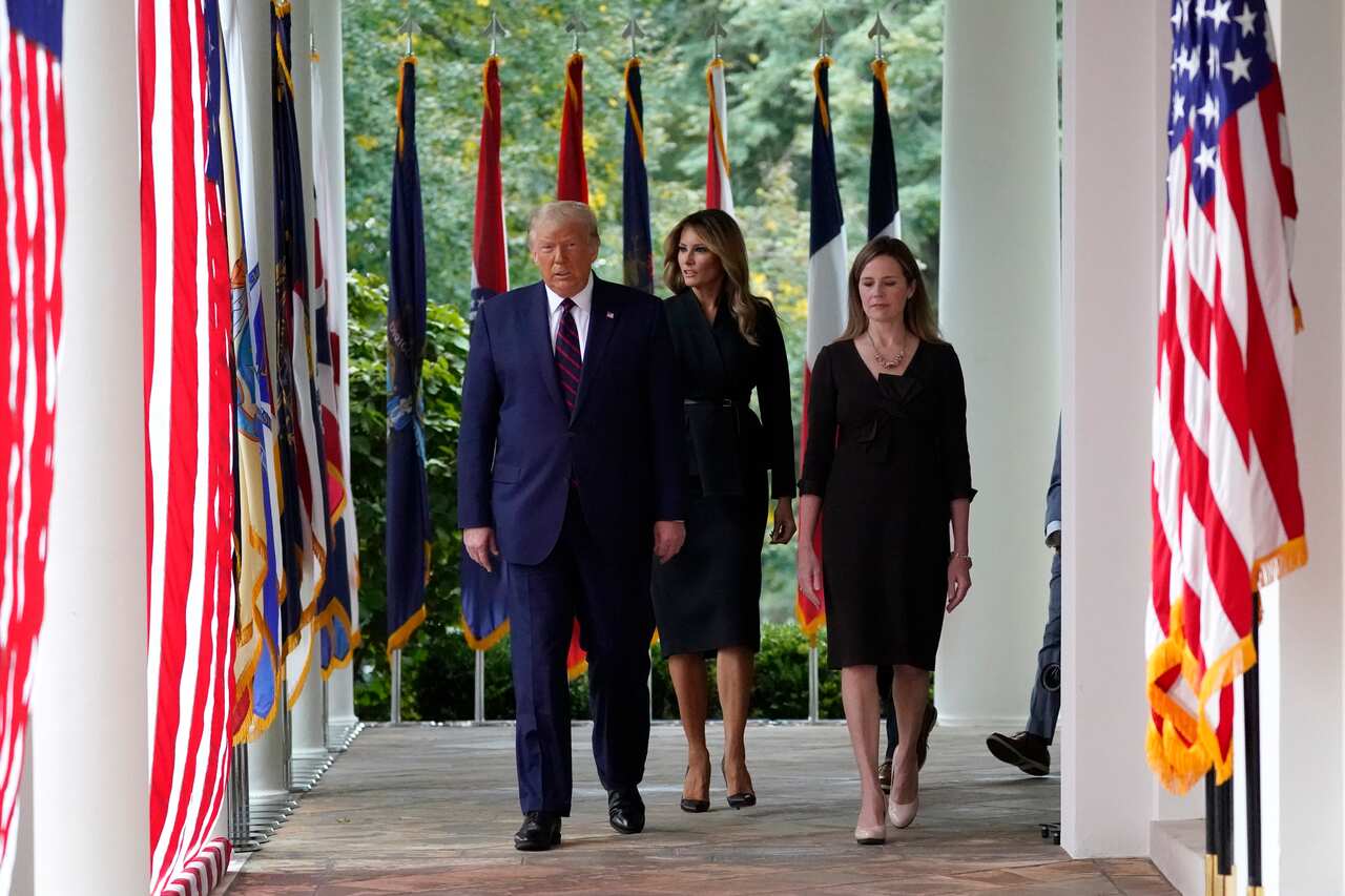 President Donald Trump walks along the Colonnade with Judge Amy Coney Barrett to a news conference to announce her as his nominee to the Supreme Court.