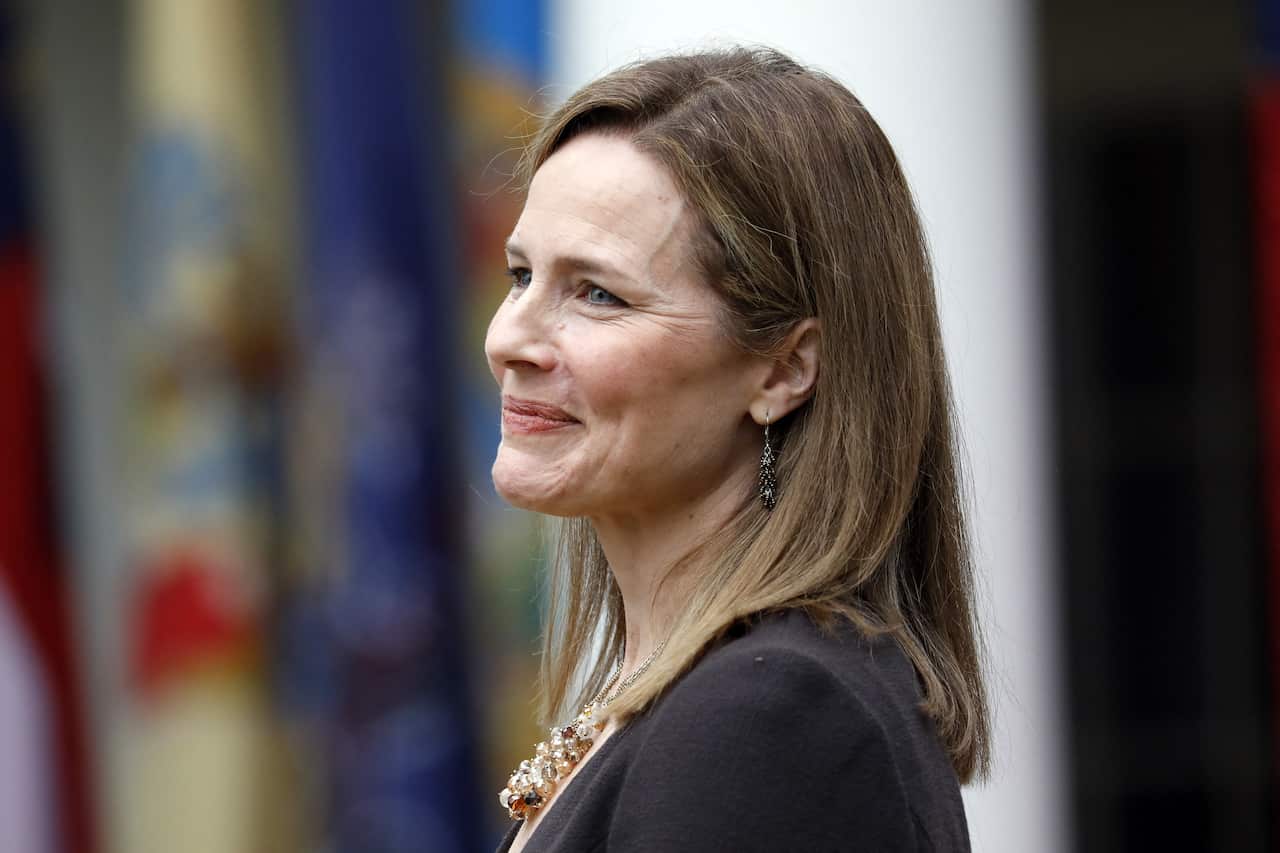 Judge Amy Coney Barrett reacts as President Donald Trump introduces her as his Supreme Court nominee.SS.COM.