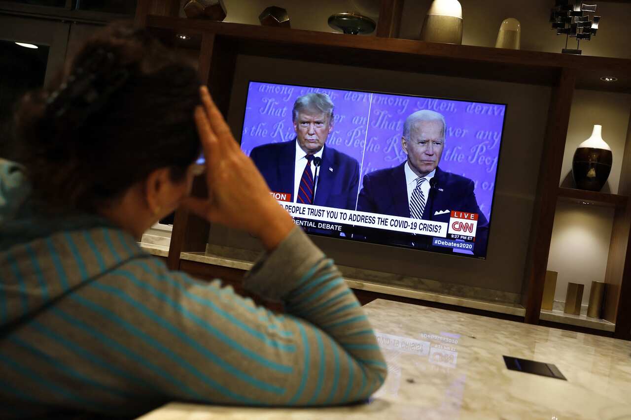 A woman watches on TV first 2020 presidential campaign debate between U.S. President Donald Trump and Democratic presidential nominee Joe Biden, in Washington on September 29, 2020. Photo by Yuri Gripas/ABACAPRESS.COM.