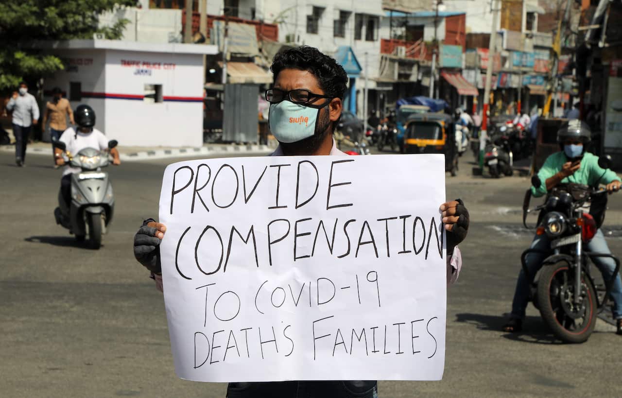 Indian social activist Sandeep Rathore holds a placard as he stands alone in the middle of a busy street, in Jammu, India, on 30 September.