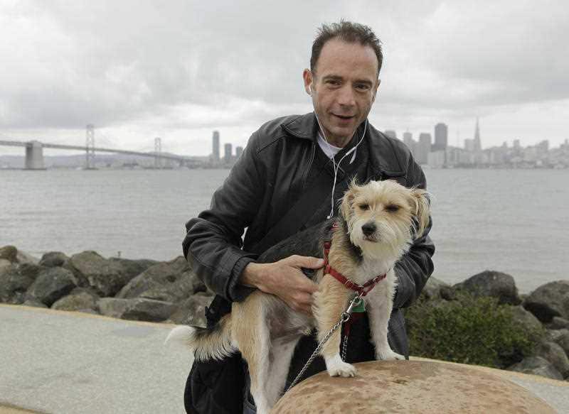 In this May 16, 2011 file photo Timothy Ray Brown poses with his dog, Jack, on Treasure Island in San Francisco
