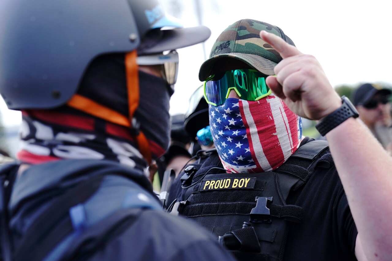 A right-wing demonstrator gestures toward a counter protester as members of the Proud Boys and other right-wing demonstrators rally in Portland.