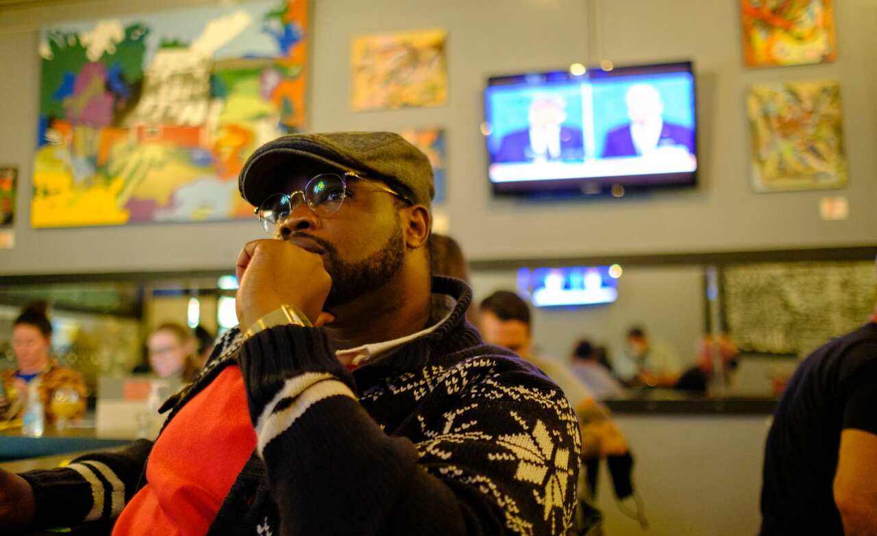 Bloomington, Indiana resident Vauhxx Booker watches on television at the Sinkhole Craft Beer Bar as United States Republican President Donald J. Trump and Democratic opponent former Vice President Joe Biden debate. The Cleveland debate was the first of se