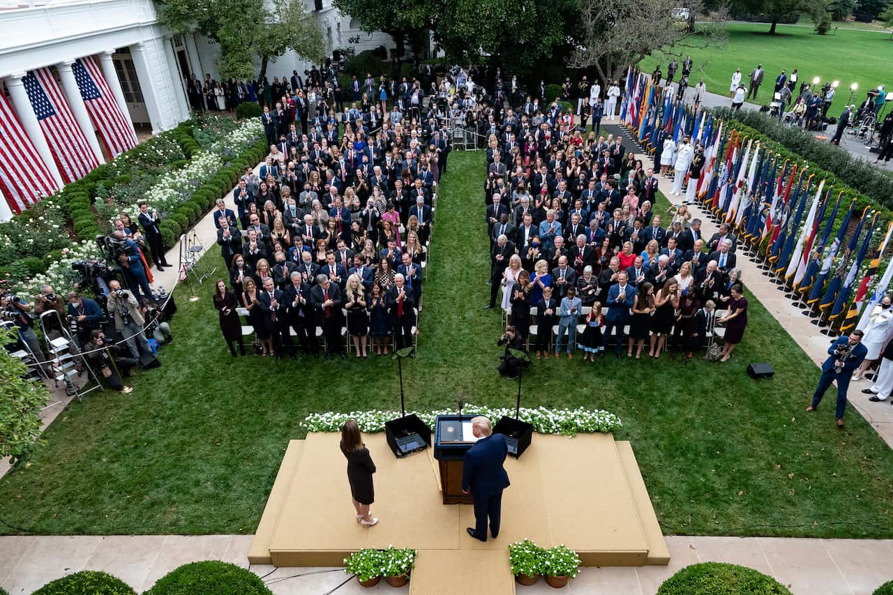 President Donald Trump stands with Judge Amy Coney Barrett as they announce her as his nominee to the Supreme Court, in the White House Rose Garden.
