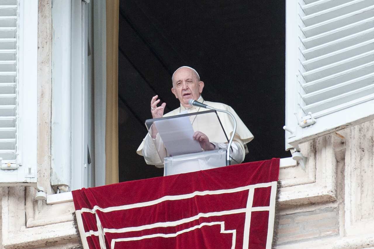 Pope Francis delivers his blessing during the Angelus noon prayer.