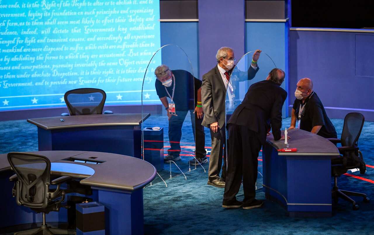 The plexiglass gets a final inspection and polish during preparations for the VP debate.