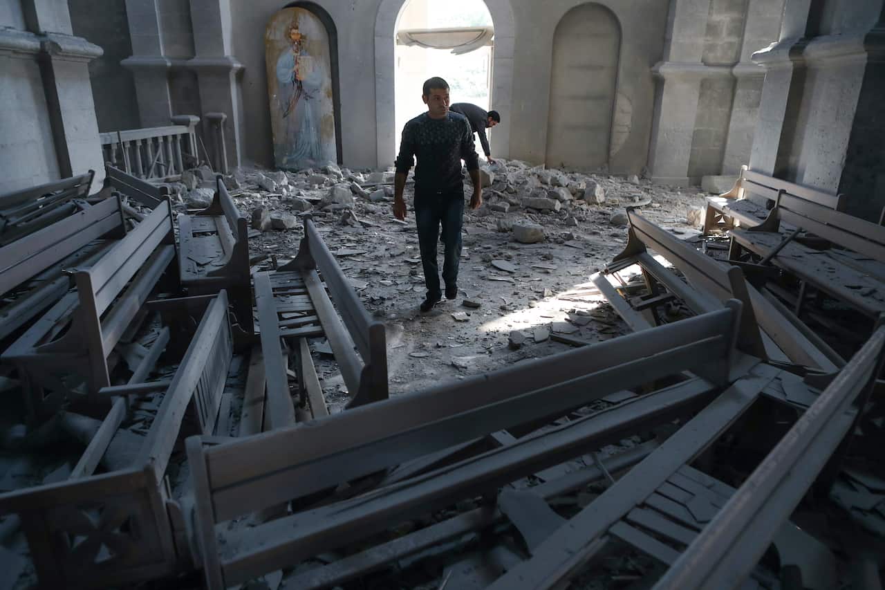 A man walks in rubble of the Ghazanchetsots (Holy Saviour) Cathedral in Shusha, some 15 kilometres from the Nagorno-Karabakh province's capital Stepanakert.