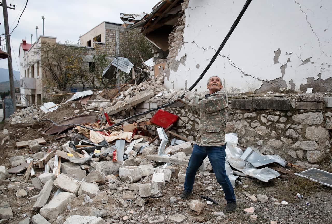 An electrician repairs a power line damaged by shelling after the beginning of the ceasefire in Stepanakert, the separatist region of Nagorno-Karabakh.