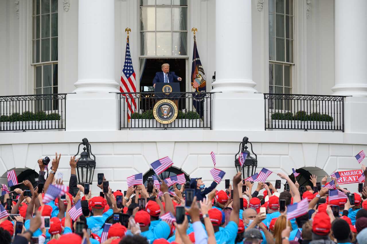 President Donald Trump speaks from the Truman Balcony of the White House in Washington on 10 October.