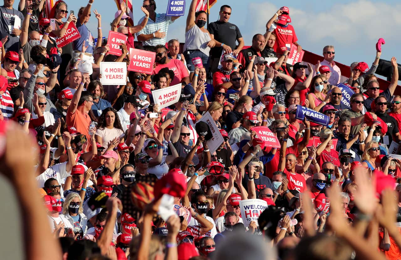 Supporters cheer waiting for President Donald Trump to arrive at a campaign rally at Orlando-Sanford International Airport in Sanford, Florida on Monday, Oct. 12, 2020. (Joe Burbank/Orlando Sentinel/TNS/Sipa USA)