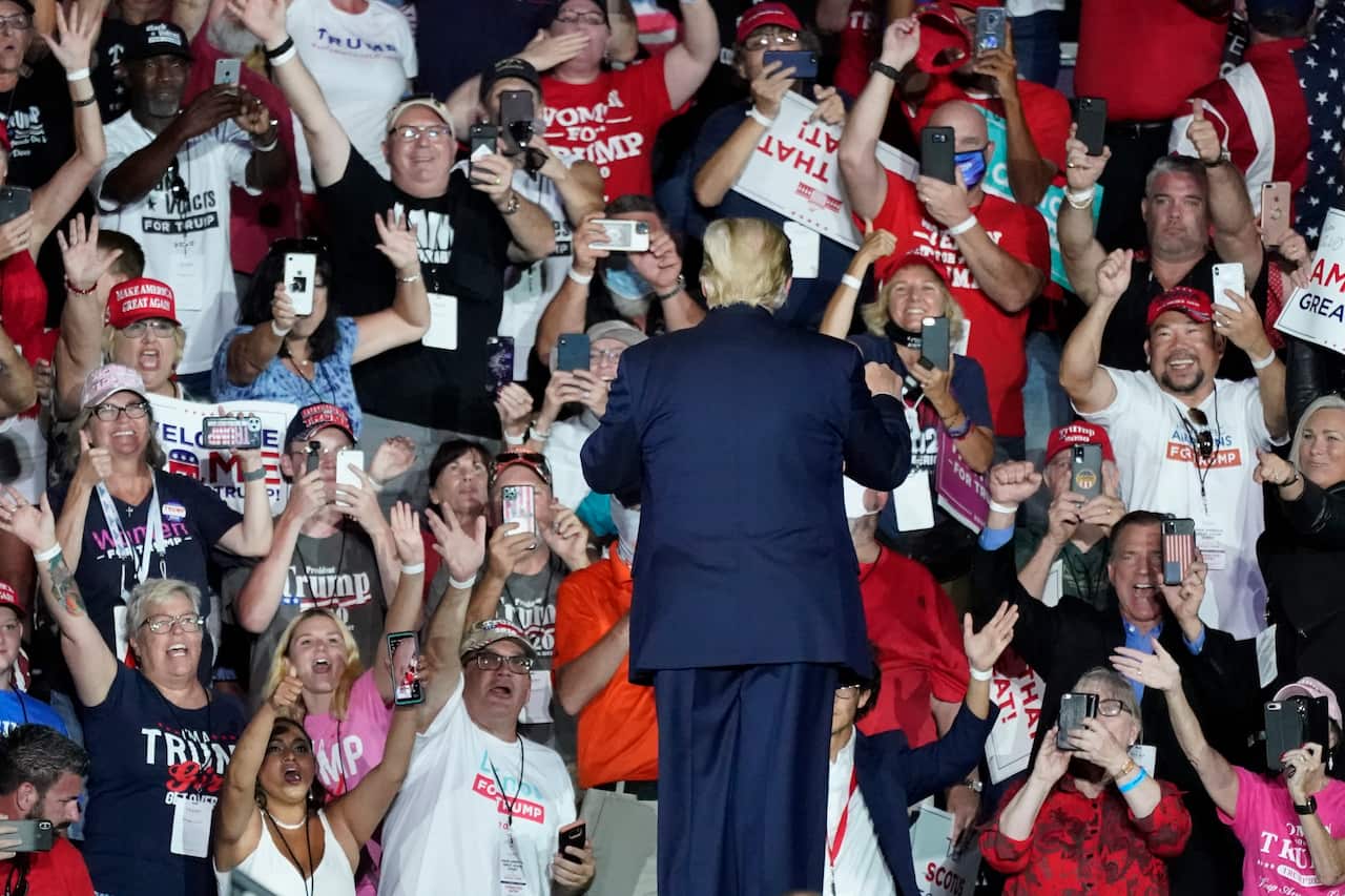 Supporters cheer as President Donald Trump leaves the campaign rally at the Orlando Sanford International Airport on Monday.