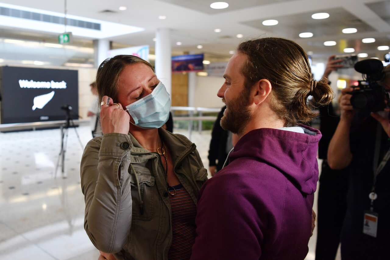 Stacey Brown is welcomed home by her partner Adam Drape as she arrives from New Zealand arrive at Sydney International Airport in Sydney in October 2020.