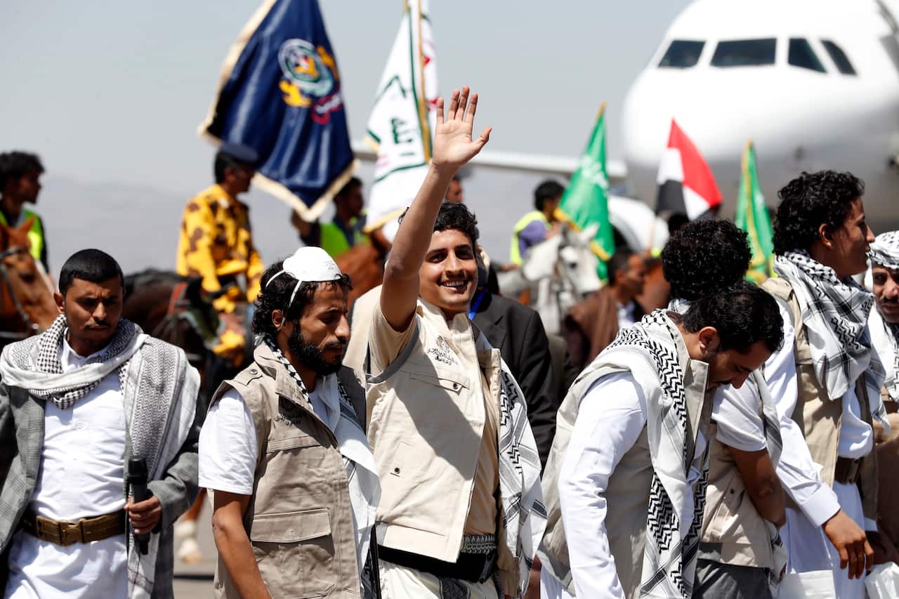 Exchanged Yemenis loyal to the Houthis arrive at Sana'a Airport on the second day of a prisoner swap.