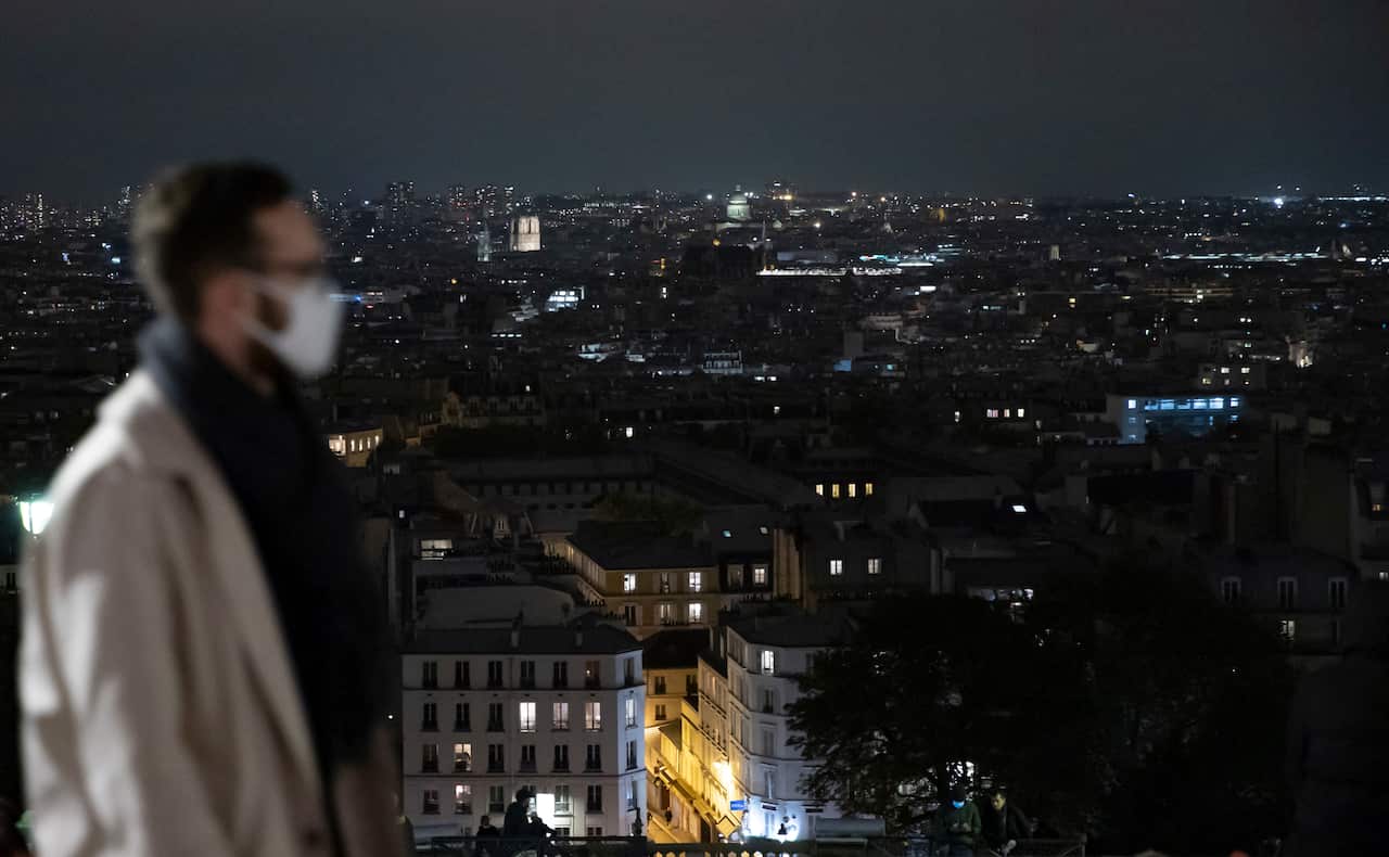 The Paris skyline is seen on 16 October 2020, just hours before a city-wide night time curfew goes into effect 