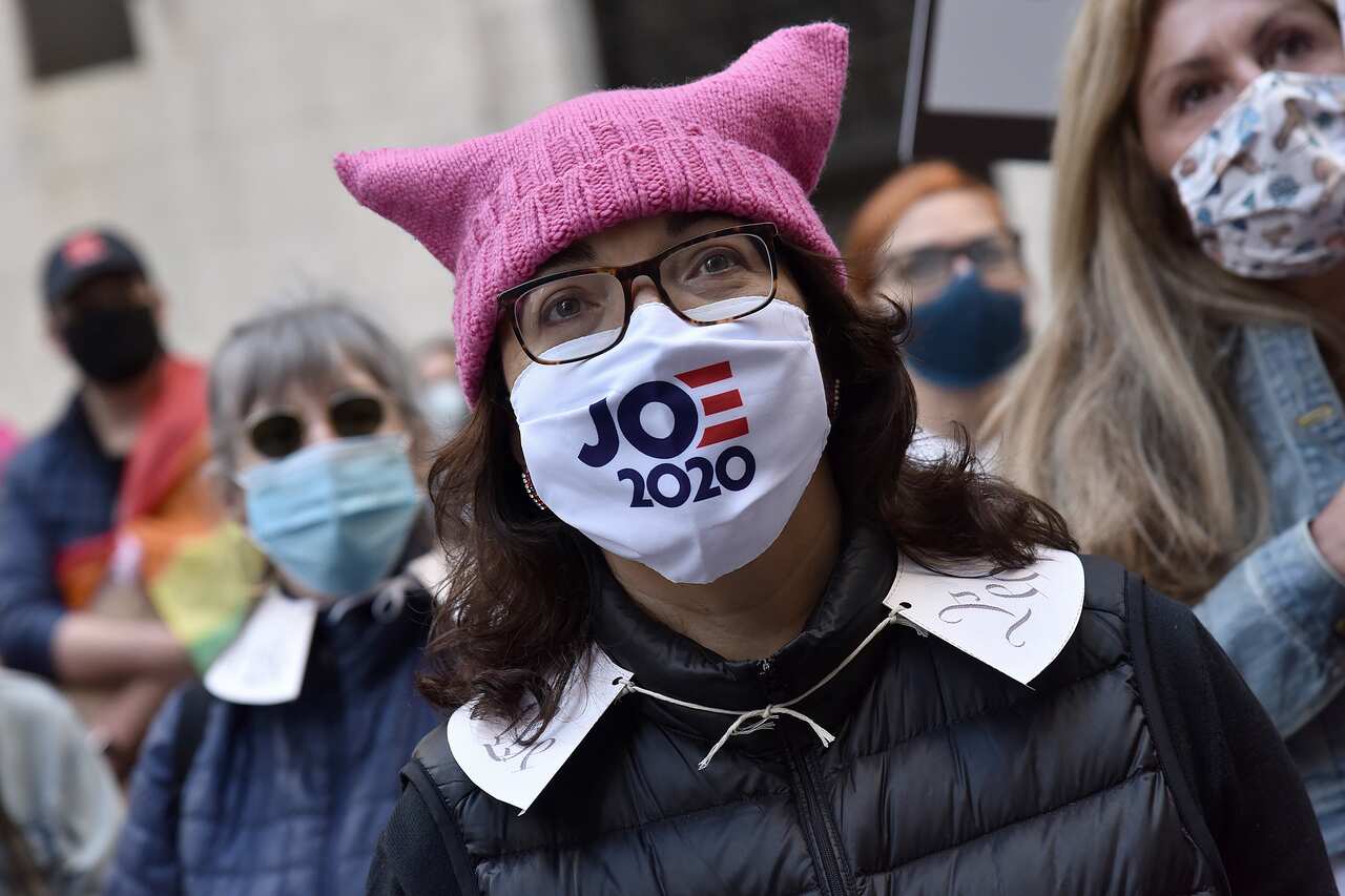 A protester wears a Joe Biden 2020 face mask as she attends a Women's March in New York. 