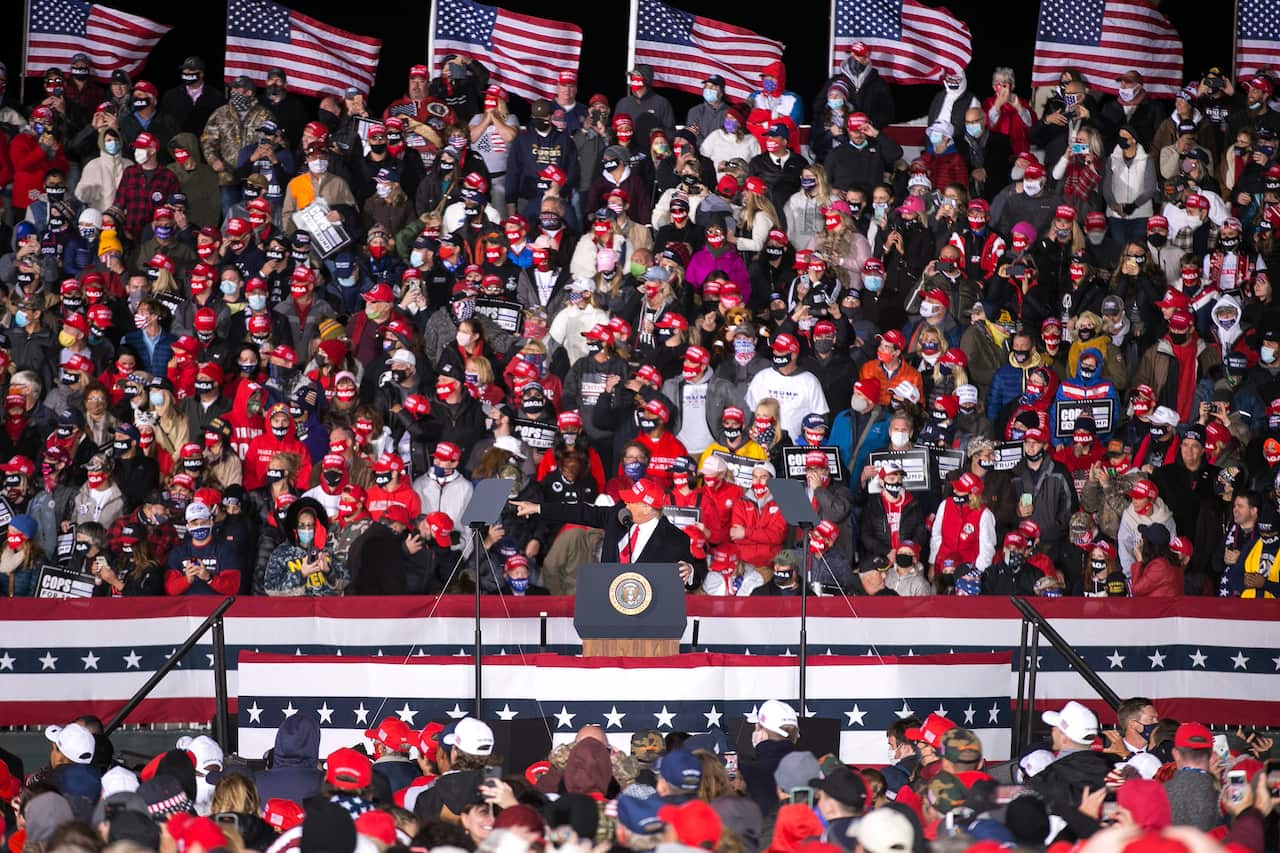 Mr Trump appears at an explosive campaign rally in Wisconsin.