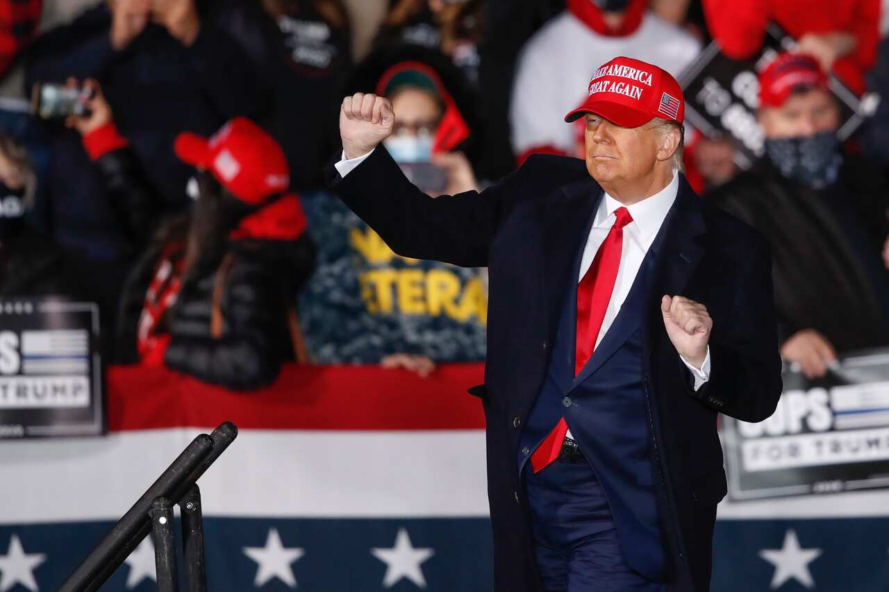 US President Donald Trump dances on stage after speaking at a campaign rally at the Southern Wisconsin Regional Airport in Janesville.