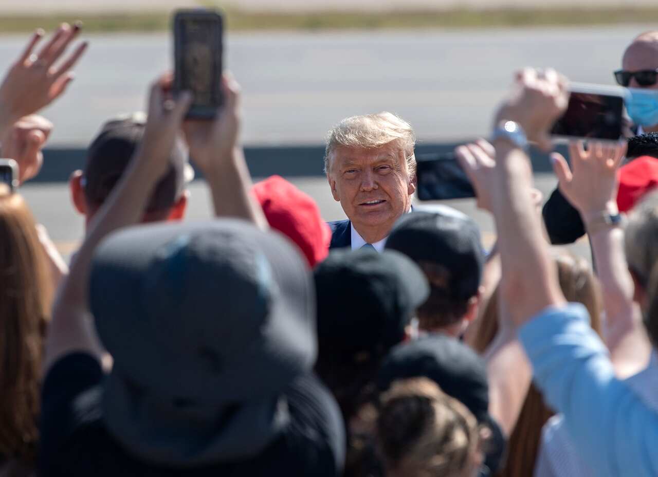 Trump supporters with special clearance greet the president as he lands at John Wayne Airport in Santa Ana on Sunday.