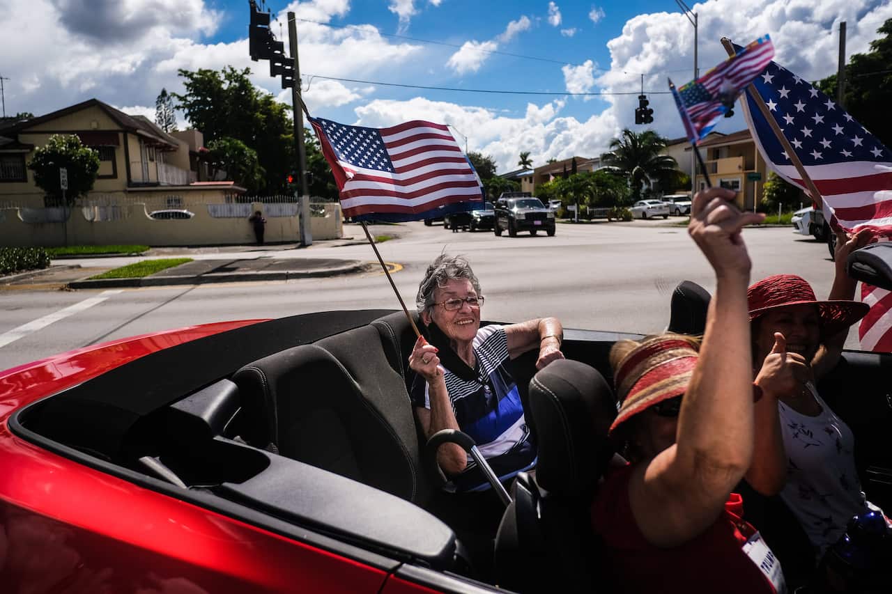 epaselect epa08756474 Demonstrators participate in 'Latinos for Trump' demonstration, a parade in support of US President Donald J. Trump, at Tamiami Park in Miami, USA, 18 October 2020.  EPA/MARIO CRUZ